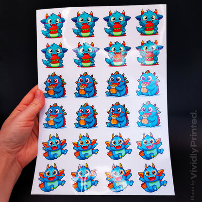 A hand holding a sticker sheet with colourful blue dragon designs