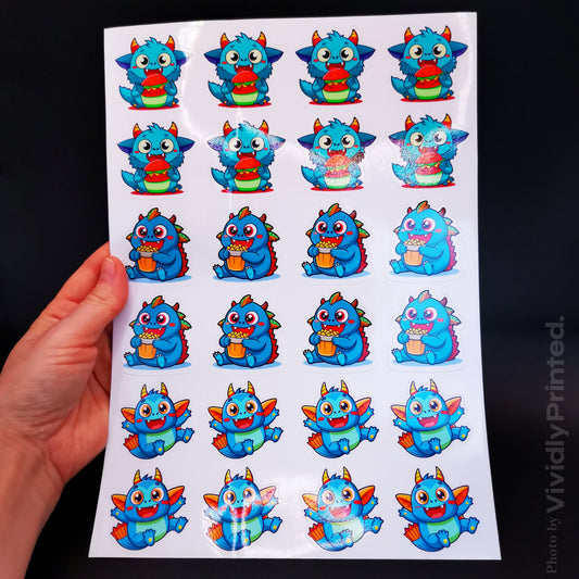 A hand holding a sticker sheet with colourful blue dragon designs