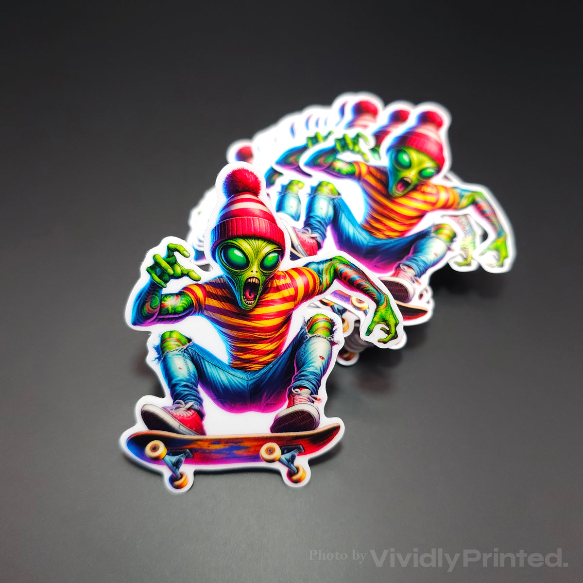 Die-cut stickers with a colourful alien riding a skateboard