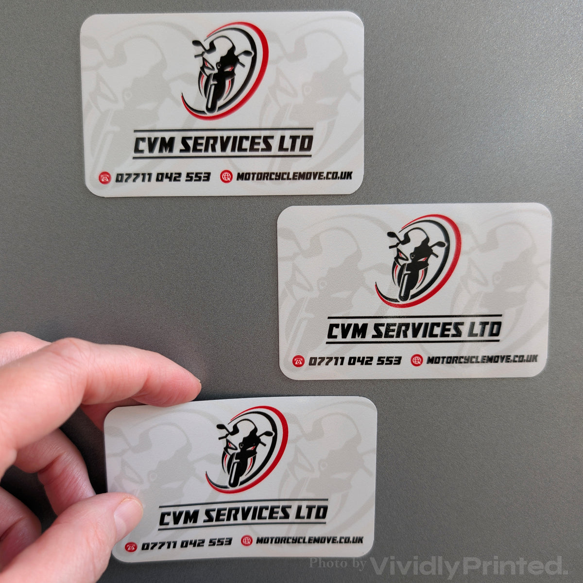 CVM Services Ltd magnetic business cards on a grey surface