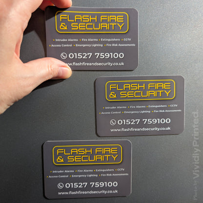 Flash Fire and Security magnetic business cards on a grey surface