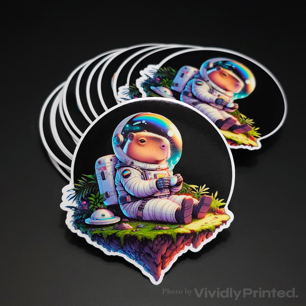 Die-cut stickers with an astronaut sitting on a floating island