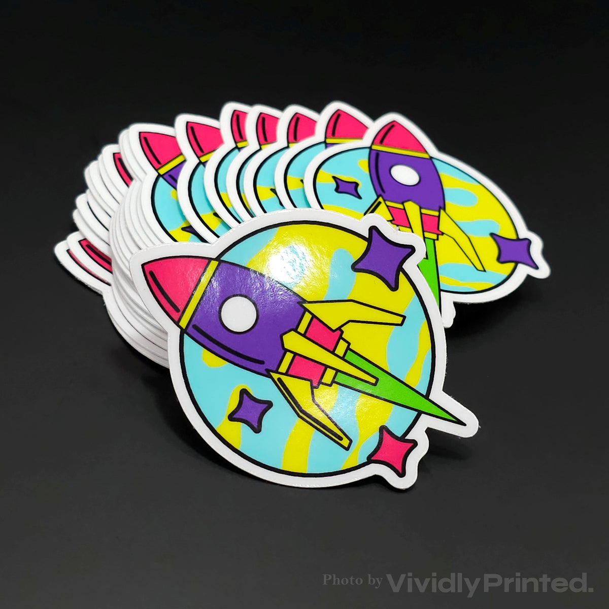 Die-cut rocket stickers with a purple rocket and colourful stars
