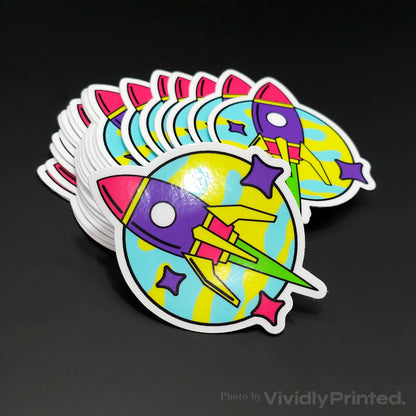 Die-cut rocket stickers with a purple rocket and colourful stars