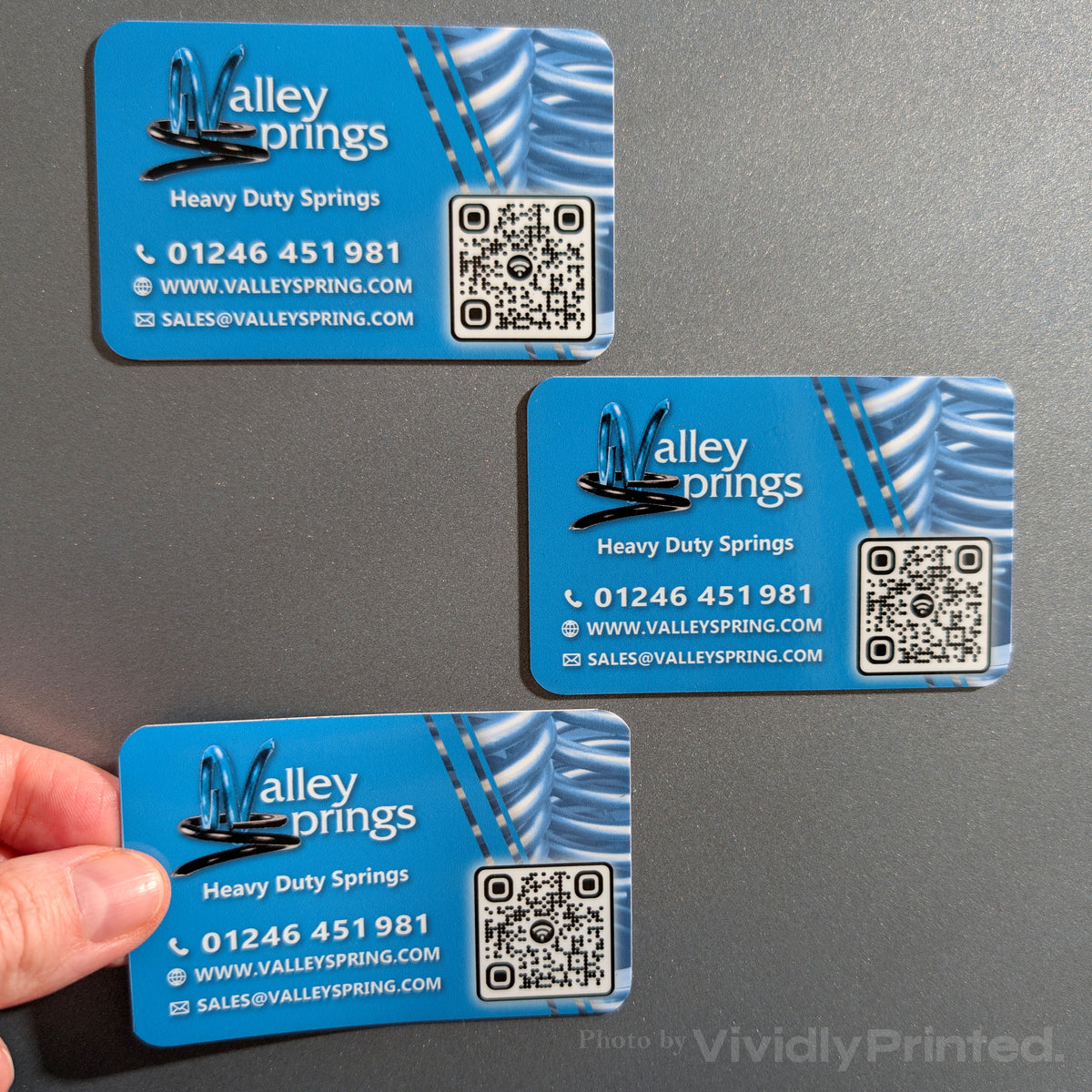 Blue Valley Springs magnetic business cards displayed on a grey surface