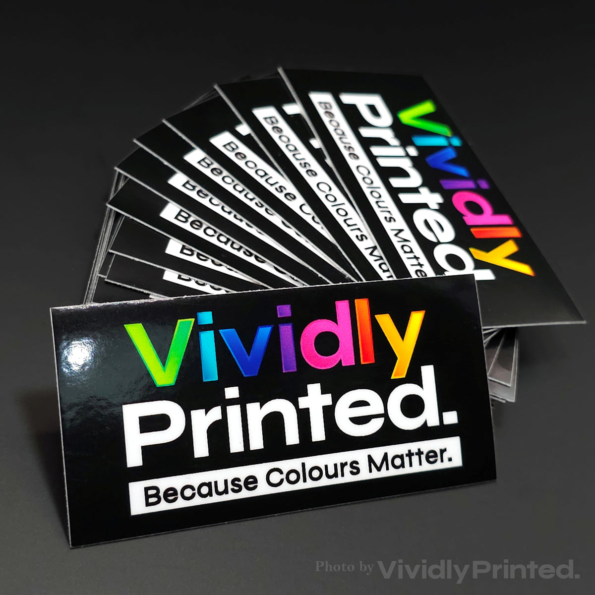Black VividlyPrinted business stickers with a colourful logo
