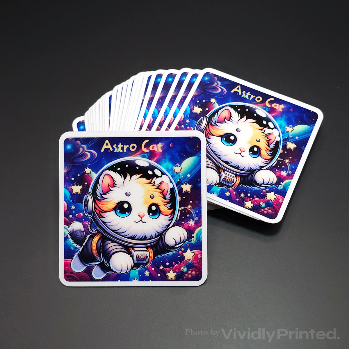 Square stickers with an Astro Cat illustration and white borders